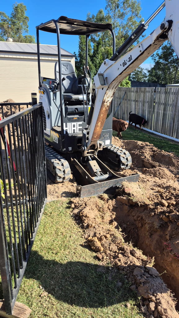 E20 excavator digging in narrow side access